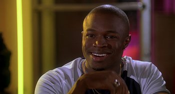 Movie still from “Can't Hardly Wait” (1998), directed by Deborah Kaplan – A person smiling with his hand on his chin; Close Up shot, Over the shoulder angle
