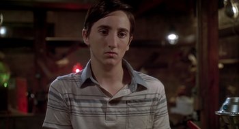 Movie still from “Can't Hardly Wait” (1998), directed by Deborah Kaplan – A young man in a striped shirt looking at the camera; Close Up shot, Low angle
