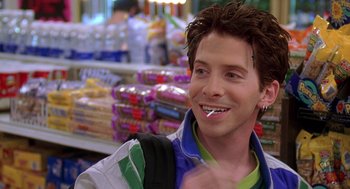 Movie still from “Can't Hardly Wait” (1998), directed by Deborah Kaplan – A man with a tooth brush in his mouth in a store; Close Up shot, Over the shoulder angle