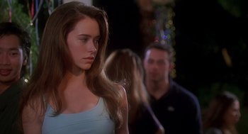 Movie still from “Can't Hardly Wait” (1998), directed by Deborah Kaplan – A woman standing in front of two other people; Close Up shot, Over the shoulder angle