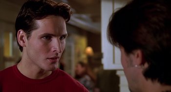 Movie still from “Can't Hardly Wait” (1998), directed by Deborah Kaplan – A man in a red shirt talking to another man in a red shirt; Close Up shot, Over the shoulder angle