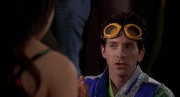Movie still from “Can't Hardly Wait” (1998), directed by Deborah Kaplan – A man with goggles on his face and a woman in a bikini; Close Up shot, Over the shoulder angle