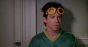 Movie still from “Can't Hardly Wait” (1998), directed by Deborah Kaplan – A young man wearing a pair of yellow goggles; Close Up shot, Over the shoulder angle