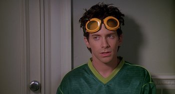 Movie still from “Can't Hardly Wait” (1998), directed by Deborah Kaplan – A man wearing goggles and a green shirt; Close Up shot, Over the shoulder angle