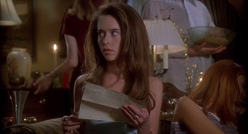 Movie still from “Can't Hardly Wait” (1998), directed by Deborah Kaplan – A woman holding an envelope in her hands; Close Up shot, Over the shoulder angle