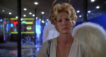 Movie still from “Can't Hardly Wait” (1998), directed by Deborah Kaplan – A woman wearing a white dress with a halo around her head; Medium shot, Low angle