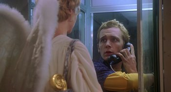Movie still from “Can't Hardly Wait” (1998), directed by Deborah Kaplan – A man talking on a phone while standing next to a woman; Close Up shot, Low angle