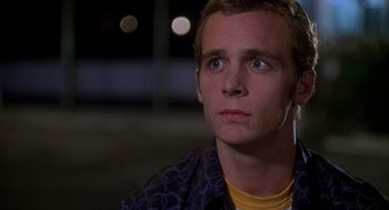 Movie still from “Can't Hardly Wait” (1998), directed by Deborah Kaplan – A young man with headphones looking up at the sky; Close Up shot, Low angle