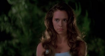 Movie still from “Can't Hardly Wait” (1998), directed by Deborah Kaplan – A woman with long brown hair looking at the camera; Close Up shot, Over the shoulder angle