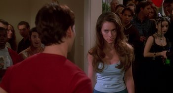 Movie still from “Can't Hardly Wait” (1998), directed by Deborah Kaplan – A woman in a red shirt is looking at a man in a blue shirt; Medium shot, Over the shoulder angle