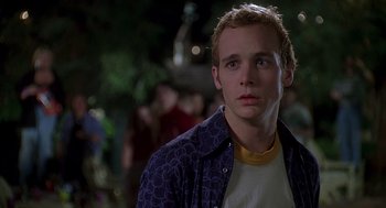 Movie still from “Can't Hardly Wait” (1998), directed by Deborah Kaplan – A man in a blue jacket looking to his left; Close Up shot, Low angle