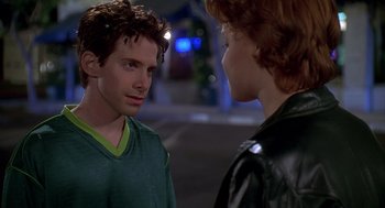 Movie still from “Can't Hardly Wait” (1998), directed by Deborah Kaplan – A man and a woman standing next to each other on the street; Close Up shot, Over the shoulder angle