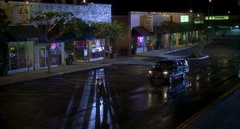 Movie still from “Can't Hardly Wait” (1998), directed by Deborah Kaplan – A car driving down a street at night; Extreme Wide shot, High angle