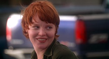 Movie still from “Can't Hardly Wait” (1998), directed by Deborah Kaplan – A person with red hair smiling; Close Up shot, Over the shoulder angle