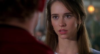 Movie still from “Can't Hardly Wait” (1998), directed by Deborah Kaplan – A young woman looking at the camera with a serious look on her face; Close Up shot, Over the shoulder angle