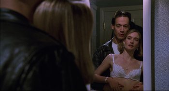 Movie still from “Candyman” (1992), directed by Bernard Rose – A man and a woman in front of a bathroom mirror; Medium shot, Low angle