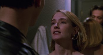 Movie still from “Candyman” (1992), directed by Bernard Rose – A woman looking at a man in the mirror; Close Up shot, Over the shoulder angle