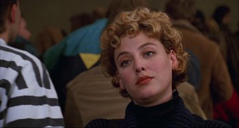 Movie still from “Candyman” (1992), directed by Bernard Rose – A person with curly blonde hair; Close Up shot, Over the shoulder angle