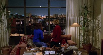 Movie still from “Candyman” (1992), directed by Bernard Rose – Two women sitting on a couch looking out of a window; Wide shot, High angle