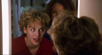 Movie still from “Candyman” (1992), directed by Bernard Rose – A woman in a red shirt talking to two other women; Close Up shot, Over the shoulder angle