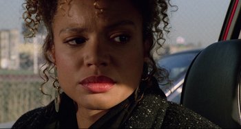 Movie still from “Candyman” (1992), directed by Bernard Rose – A person with curly hair; Close Up shot, Over the shoulder angle