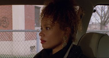 Movie still from “Candyman” (1992), directed by Bernard Rose – A woman sitting in the back seat of a car; Close Up shot, High angle