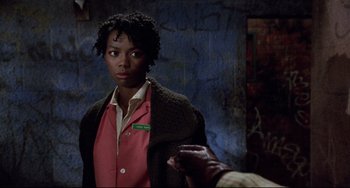 Movie still from “Candyman” (1992), directed by Bernard Rose – A woman standing in front of a wall; Close Up shot, Over the shoulder angle