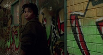Movie still from “Candyman” (1992), directed by Bernard Rose – A person standing in front of a wall covered in graffiti; Close Up shot, Low angle