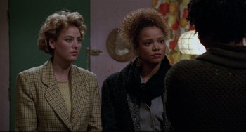 Movie still from “Candyman” (1992), directed by Bernard Rose – Two women are standing next to each other in front of a mirror; Medium shot, Over the shoulder angle
