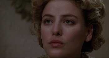 Movie still from “Candyman” (1992), directed by Bernard Rose – A woman's face with green eyes; Close Up shot, Over the shoulder angle