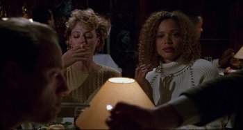 Movie still from “Candyman” (1992), directed by Bernard Rose – Two women sitting in front of a lamp in a room; Medium shot, Over the shoulder angle