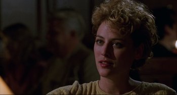 Movie still from “Candyman” (1992), directed by Bernard Rose – A person with curly blonde hair; Close Up shot, Over the shoulder angle