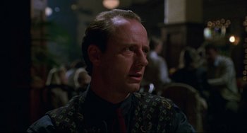 Movie still from “Candyman” (1992), directed by Bernard Rose – A person wearing a tie; Close Up shot, Over the shoulder angle