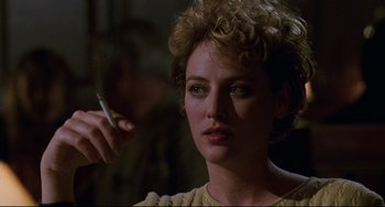 Movie still from “Candyman” (1992), directed by Bernard Rose – A person holding a cigarette in her hand; Close Up shot, Over the shoulder angle