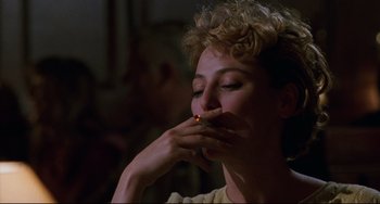 Movie still from “Candyman” (1992), directed by Bernard Rose – A woman with a cigarette in her mouth; Close Up shot, Over the shoulder angle