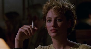 Movie still from “Candyman” (1992), directed by Bernard Rose – A person holding a cigarette; Close Up shot, Over the shoulder angle