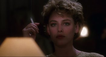 Movie still from “Candyman” (1992), directed by Bernard Rose – A person holding a cigarette; Close Up shot, Over the shoulder angle