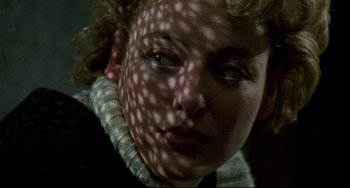 Movie still from “Candyman” (1992), directed by Bernard Rose – A woman's face with a shadow on her face; Close Up shot, Overhead angle