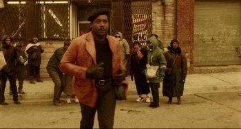 Movie still from “Candyman” (1992), directed by Bernard Rose – A group of people walking down a street; Wide shot, High angle