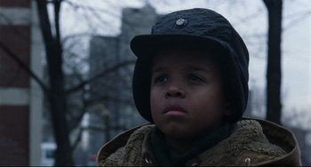 Movie still from “Candyman” (1992), directed by Bernard Rose – A little boy wearing a hat and a coat; Close Up shot, Low angle
