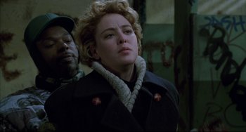 Movie still from “Candyman” (1992), directed by Bernard Rose – A woman in a black coat and a man in a black jacket; Close Up shot, Over the shoulder angle