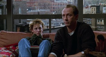 Movie still from “Candyman” (1992), directed by Bernard Rose – A man and a woman sitting next to each other on a couch; Medium shot, Over the shoulder angle