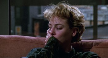 Movie still from “Candyman” (1992), directed by Bernard Rose – A woman sitting on a couch with her hand to her face; Close Up shot, High angle