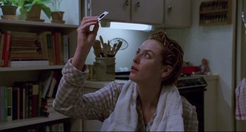 Movie still from “Candyman” (1992), directed by Bernard Rose – A woman holding a cell phone up to her face; Close Up shot, Low angle