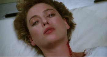 Movie still from “Candyman” (1992), directed by Bernard Rose – A person laying on a bed; Close Up shot, Overhead angle