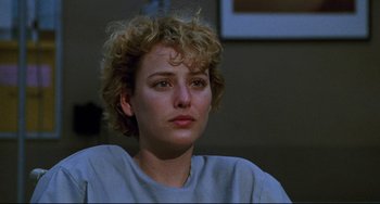 Movie still from “Candyman” (1992), directed by Bernard Rose – A person sitting in a room; Close Up shot, Over the shoulder angle
