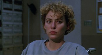 Movie still from “Candyman” (1992), directed by Bernard Rose – A person with curly blonde hair; Close Up shot, Over the shoulder angle