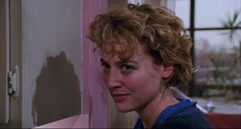 Movie still from “Candyman” (1992), directed by Bernard Rose – A person with curly brown hair; Close Up shot, Over the shoulder angle