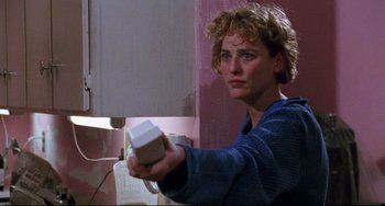 Movie still from “Candyman” (1992), directed by Bernard Rose – A woman holding a nintendo wii game controller in her hands; Close Up shot, Low angle