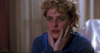 Movie still from “Candyman” (1992), directed by Bernard Rose – A person sitting with her hand on her face; Close Up shot, Over the shoulder angle